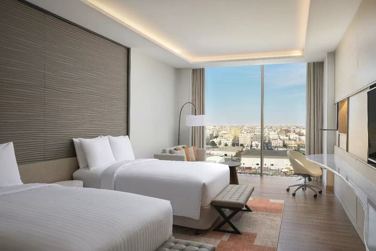 Fully furnished Marriott guest room with custom ribbed feature walls and ergonomic workstations